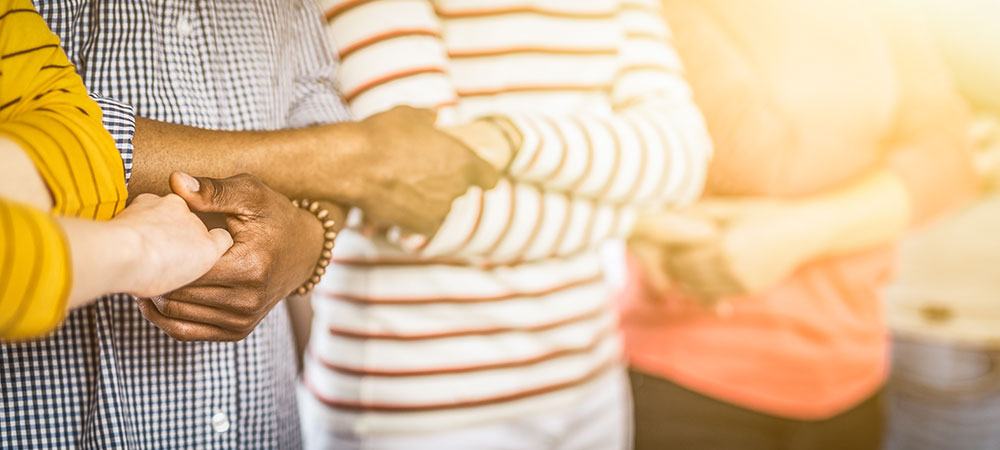 line of people with hands grasped together to form chain