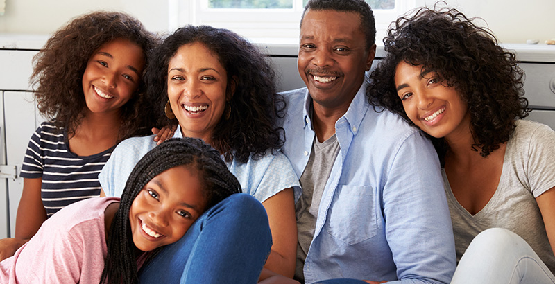 family of five sitting together smiling