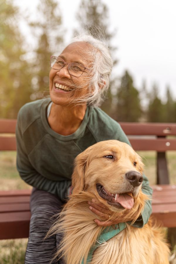 older woman hugging a dog