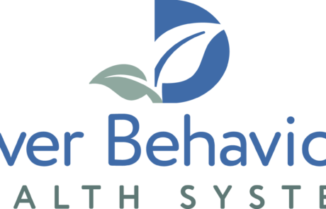 39af9e49efa48febc1fd20fd30e00a93afe4e5e1-1800x753 - NAMI Dover Behavioral Health System logo with a blue circular emblem and green leaves above the blue text.